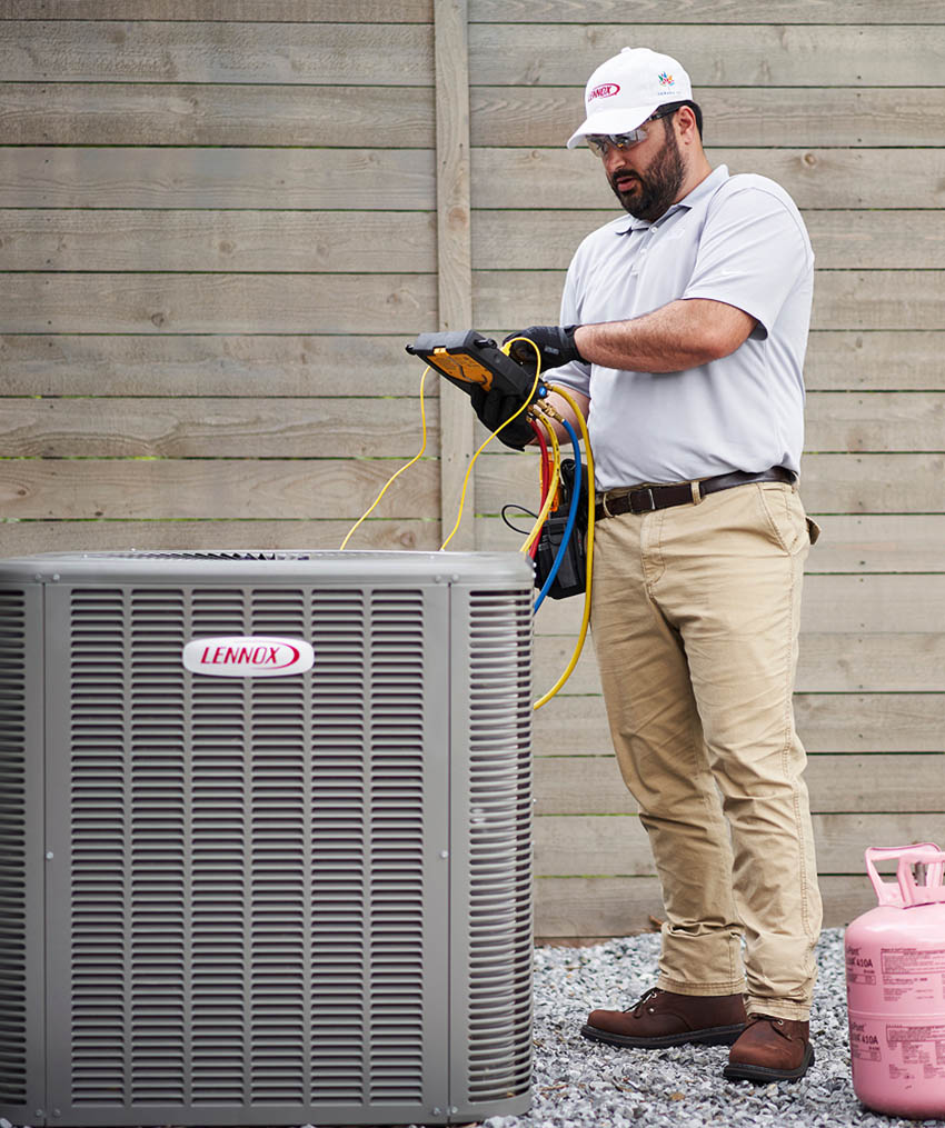 HVAC technician working on a Lennox heat pump.